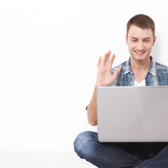 Young couple talking to each other via online video chat.