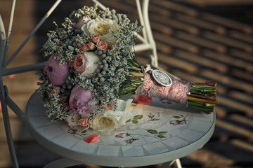 The wedding bouquet stands on the chair