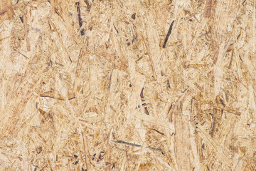 Photo used old plywood texture and background. Compressed light brown particle board panel background. Texture compressed wood shavings. Grunge old wooden texture