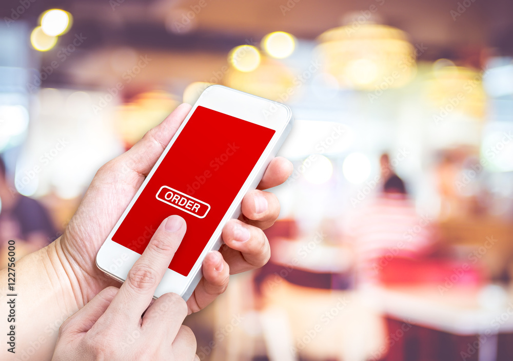 Aufkleber Hand holding mobile  with order button and empty screen for addi