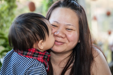little boy kissing his mom
