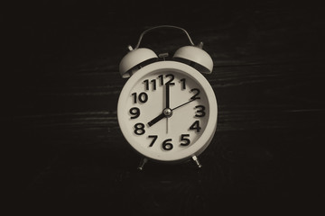 Around the Clock - Alarm clock in the middle image on antique background.