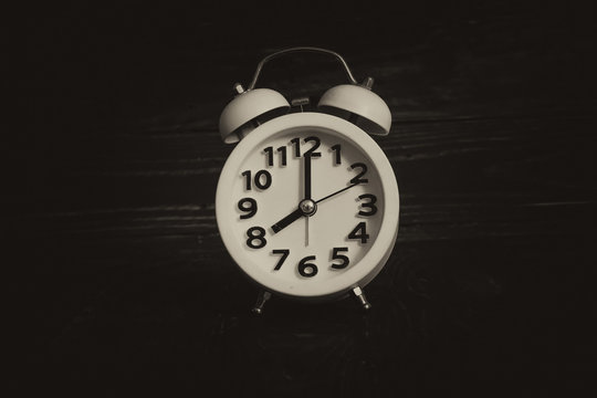 Around the Clock - Alarm clock in the middle image on antique background.