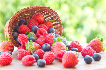 Fresh berries (raspberries, blueberries, strawberries) in basket © Maresol