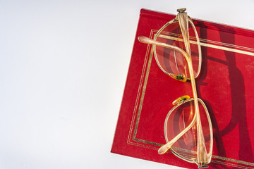 Reading Glasses Lying On The Red Book