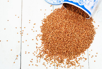 Buckwheat are scattered on a white table