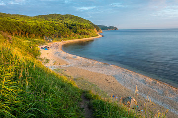 Fototapeta na wymiar sunset camping view on the beach of russian isle Putyatin
