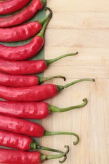 Fresh red hot chilli on wood background.