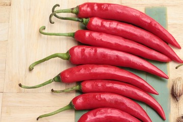 Fresh red hot chilli on wood background.