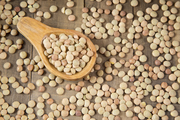 Grains of lentils in wooden spoon