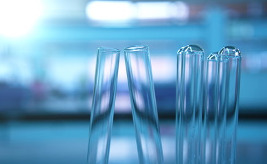 four test tube in blue science lab background