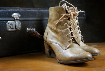 old suitcase and women's shoes closeup