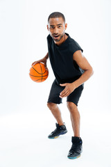Full length portrait of an african man playing basketball