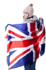 Portrait of a beautiful British girl smiling holding up the UK flag. Isolated on white.