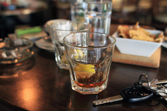 Don't drink and drive concept. Alcohol drink and car keys. Responsibly and safety driving