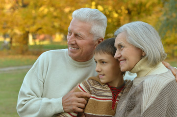 Grandparents and grandson in autumn park
