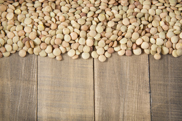 Lentil beans on wooden table - Lens culinaris