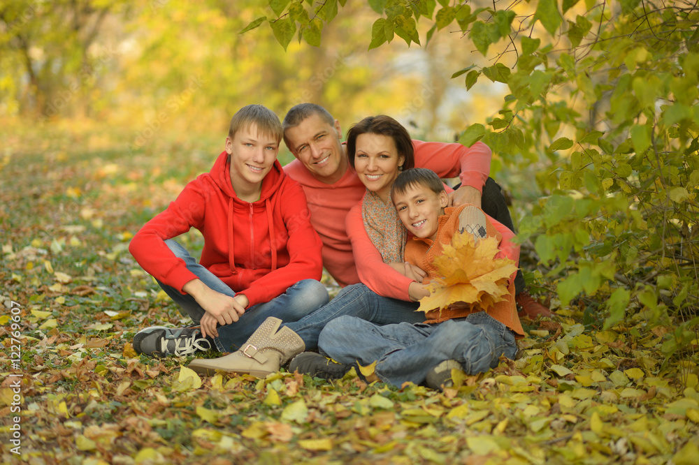 Wall mural Happy family in autumn forest