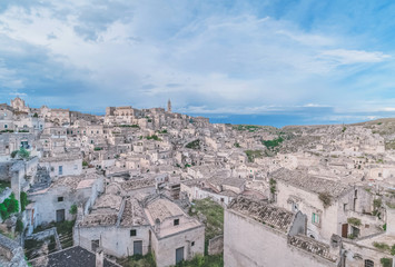 Fototapeta na wymiar panoramic view of stones (Sassi di Matera) and church of Matera under blue