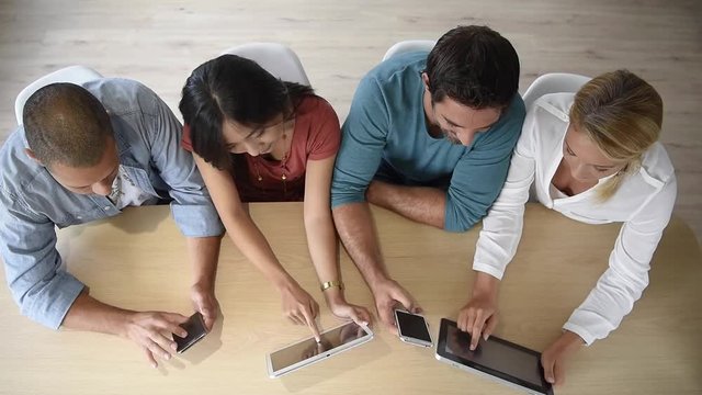 Upper view of start-up business people meeting with electronic devices