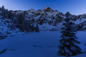 Winter night in Polish Tatra mountains, frozen Morskie Oko lake