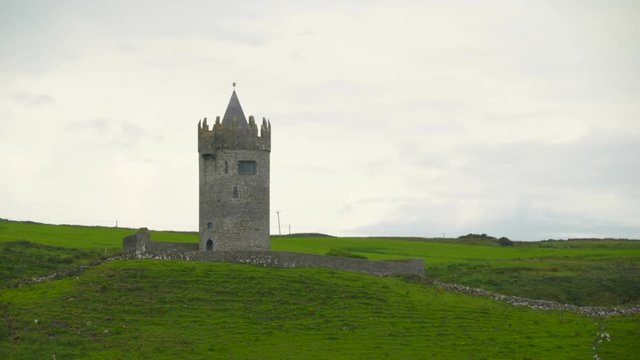 The Doonagore castle in Moher Ireland Doonagore Castle is a round 16th-century tower house with a small walled enclosure located about 1 km above the coastal village of Doolin in County Clare Ireland.