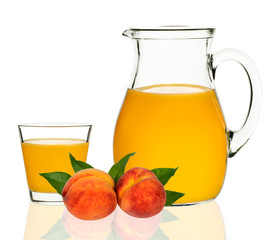 peach juice in a glass and carafe