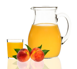 peach juice in a glass and carafe