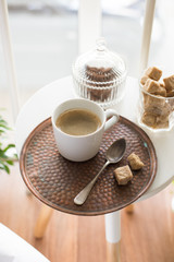 Coffee with sweets served on table in cozy loft room