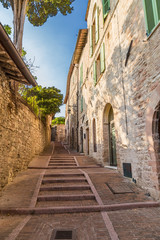 Fototapeta na wymiar Assisi, Italy. Old street with steps at the top of the town