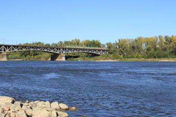 Naklejka premium Warsaw, railway bridge across the Vistula river with train