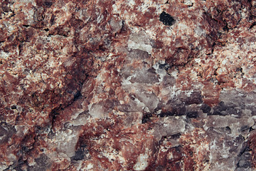 Surface of red granite close-up. Texture wild stone.