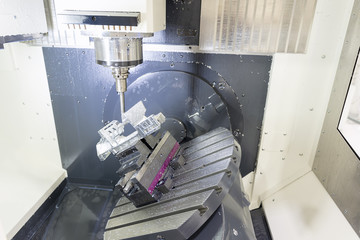 The 5-axis CNC machine while cutting the sample part of aircraft.The spindle of 5 axis CNC...