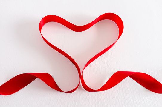 Valentine Heart. Red satin Ribbon. Isolated on white.