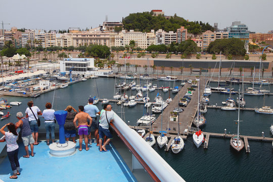 Passengers on deck of cruise liner in port. Cartagena, Spain