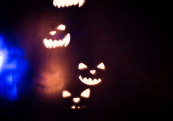 Halloween abstract glowing blurred background. Close up bokeh. Defocused blinking shaped lights....