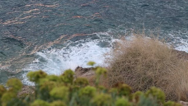 ocean waves hitting shore at sundawn in Crete, Greece