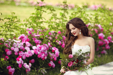 Beautiful brunette bride outdoor portrait. Woman with wedding bo