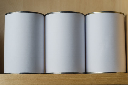 Three Tin Cans On Shelf with Blank White Labels