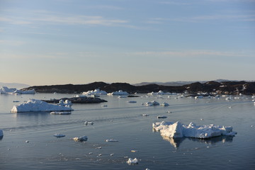 Naklejka premium icebergs are melting at arctic ocean in Greenland. Climate change.