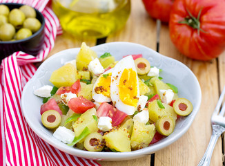 Potato salad with tomato, bell pepper, feta cheese and eggs