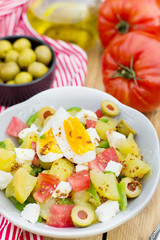 Potato salad with tomato, bell pepper, feta cheese and eggs
