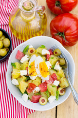 Potato salad with tomato, bell pepper, feta cheese and eggs