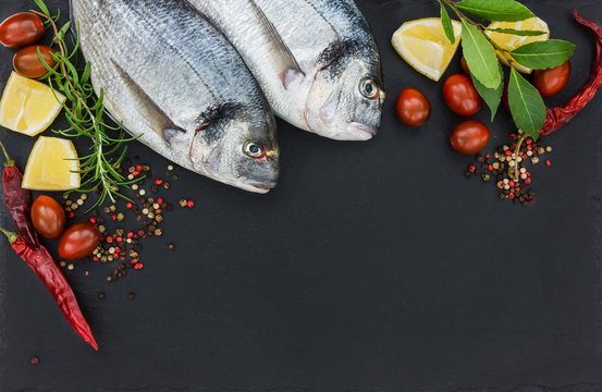 Two Fresh Dorado Fish On Black Slate Cutting Board. Top View, Copy Space. 