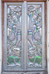 Beautiful Carved Angles Silver Door Lanna Architecture Chiangmai, THAILAND.