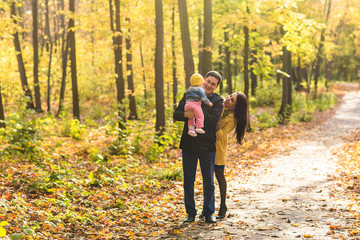 Fototapeta premium friendly family walking in the park in autumn together