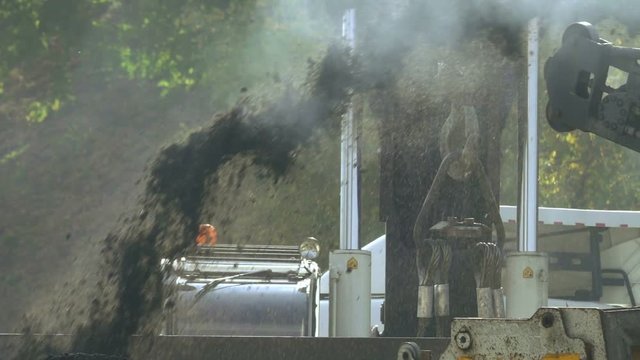 Cold milling machine grinds asphalt, slow motion