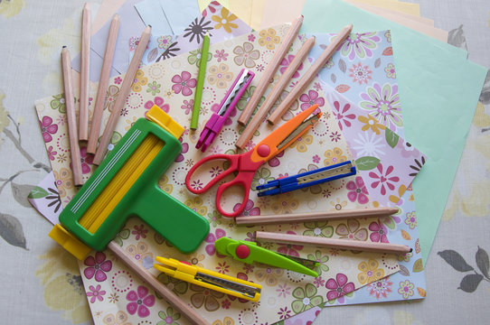 hand made scrap-booking post card and tools lying on a table