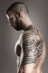Muscular tattoo man from the back - black and white photo
