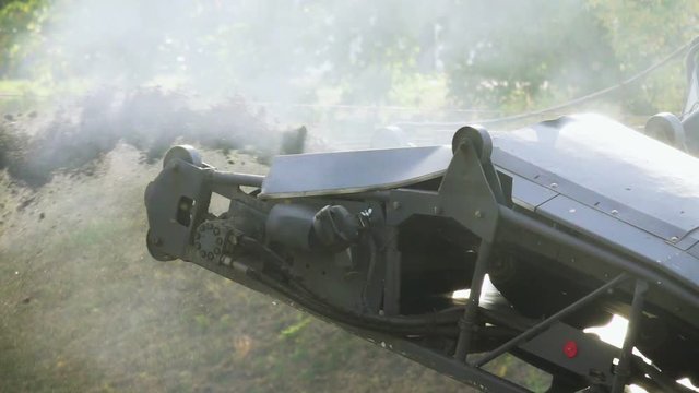 Cold milling machine, milled asphalt falls into the back of the truck, close up, side view, slow motion